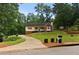 Charming home featuring a manicured front yard, long driveway, and classic architectural details at 670 Dena Dr, Canton, GA 30114