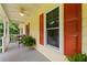 Cozy front porch featuring seating, plants, and colorful shutters for added charm at 670 Dena Dr, Canton, GA 30114