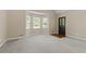 Inviting living room with neutral carpet, bay window and stained front door at 670 Dena Dr, Canton, GA 30114