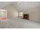 Living room with vaulted ceiling, fireplace, neutral carpet and access to back of house at 670 Dena Dr, Canton, GA 30114