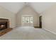 Spacious living room with vaulted ceiling, fireplace, bay window and stained front door at 670 Dena Dr, Canton, GA 30114