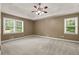 Spacious Primary bedroom with a tray ceiling, recessed lighting, and abundant natural light from two windows at 670 Dena Dr, Canton, GA 30114