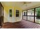 Cozy screened porch with wood floors and walls and view to backyard at 670 Dena Dr, Canton, GA 30114