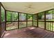 Large screened-in porch with wood floors and a peaceful wooded view at 670 Dena Dr, Canton, GA 30114