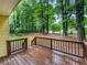 Spacious wooden back deck overlooking a lush, tree-filled backyard at 8683 Twin Oaks Dr, Jonesboro, GA 30236