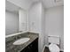 Bathroom featuring granite countertops, modern fixtures and a toilet at 8683 Twin Oaks Dr, Jonesboro, GA 30236