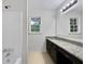 Bathroom featuring modern vanity with a granite countertop and a shower at 8683 Twin Oaks Dr, Jonesboro, GA 30236