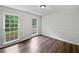 Bedroom featuring hardwood floors and double-hung windows with views of the outdoors at 8683 Twin Oaks Dr, Jonesboro, GA 30236