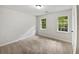 Bedroom featuring plush carpeting and double-hung windows with views of the outdoors at 8683 Twin Oaks Dr, Jonesboro, GA 30236