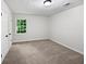Bedroom featuring plush carpeting and a double-hung window with views of the outdoors at 8683 Twin Oaks Dr, Jonesboro, GA 30236