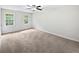 Bedroom featuring plush carpeting, a ceiling fan, and double-hung windows at 8683 Twin Oaks Dr, Jonesboro, GA 30236