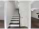 Entryway with staircase leading to upper levels and access to the living room at 8683 Twin Oaks Dr, Jonesboro, GA 30236