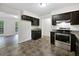 Modern kitchen with stainless steel appliances and dark cabinets at 8683 Twin Oaks Dr, Jonesboro, GA 30236
