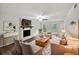 Cozy living room with a brick fireplace, neutral furnishings, and abundant natural light at 8683 Twin Oaks Dr, Jonesboro, GA 30236
