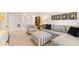 Spacious basement featuring a gray sectional couch, striped ottoman, and contemporary decor at 1288 Hollingsworth Way, Dacula, GA 30019