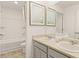 Bright bathroom featuring dual sinks, decorative art, and a bathtub-shower combo at 1288 Hollingsworth Way, Dacula, GA 30019