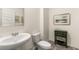 Elegant powder room with pedestal sink, decorative mirror and stylish accents at 1288 Hollingsworth Way, Dacula, GA 30019