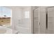Bright bathroom with soaking tub and glass shower enclosure at 1288 Hollingsworth Way, Dacula, GA 30019