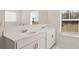 Bathroom featuring double vanity with quartz countertop and modern fixtures at 1288 Hollingsworth Way, Dacula, GA 30019