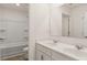 Bathroom featuring a double sink vanity, a large mirror, and a tub/shower combo at 1288 Hollingsworth Way, Dacula, GA 30019