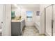 Bathroom features a double sink vanity, a large window, and a glass-enclosed shower adjacent to a tub at 1288 Hollingsworth Way, Dacula, GA 30019