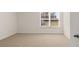 Bright bedroom with neutral carpet and a large window offering natural light at 1288 Hollingsworth Way, Dacula, GA 30019