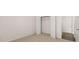 Bright bedroom with neutral carpet and a closet with white bi-fold doors at 1288 Hollingsworth Way, Dacula, GA 30019