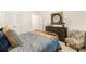 Cozy bedroom with neutral decor, a chest of drawers and a sitting chair at 1288 Hollingsworth Way, Dacula, GA 30019