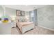 Bright bedroom featuring a soft pink bedspread, colorful floral curtains, and matching butterfly artwork at 1288 Hollingsworth Way, Dacula, GA 30019