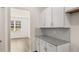 A butler pantry area with white cabinets and granite countertop at 1288 Hollingsworth Way, Dacula, GA 30019