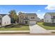 Charming two-story home with a mix of stone and siding, featuring a well-manicured lawn and a paved driveway at 1288 Hollingsworth Way, Dacula, GA 30019