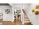 Spacious foyer featuring hardwood floors, staircase, neutral walls, and views into living spaces at 1288 Hollingsworth Way, Dacula, GA 30019