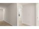 Carpeted hallway with view into the bedroom and to another room at the end at 1288 Hollingsworth Way, Dacula, GA 30019