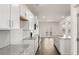 Bright kitchen features stainless appliances, granite countertops, and white cabinetry at 1288 Hollingsworth Way, Dacula, GA 30019