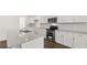 A kitchen features stainless steel appliances, a large island, and white cabinets at 1288 Hollingsworth Way, Dacula, GA 30019