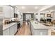 Modern kitchen boasts an open floor plan, seamlessly connecting the cooking area to the dining and living spaces at 1288 Hollingsworth Way, Dacula, GA 30019