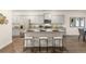 Modern kitchen with gray cabinets, granite countertops, and stainless-steel appliances at 1288 Hollingsworth Way, Dacula, GA 30019