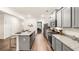 Bright kitchen features gray cabinets, granite countertops, stainless appliances, and a convenient center island at 1288 Hollingsworth Way, Dacula, GA 30019