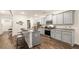 Stylish kitchen featuring gray cabinets, granite countertops, and central island with seating at 1288 Hollingsworth Way, Dacula, GA 30019