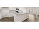 A kitchen features an island, stainless steel appliances, white cabinets, and granite countertops at 1288 Hollingsworth Way, Dacula, GA 30019