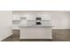 White kitchen featuring an island, granite countertops, and stainless steel appliances at 1288 Hollingsworth Way, Dacula, GA 30019