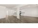 Spacious open living area with hardwood floors and kitchen featuring white cabinets at 1288 Hollingsworth Way, Dacula, GA 30019