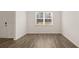 Well-lit room with hardwood floors, white trim, and a white door on the left at 1288 Hollingsworth Way, Dacula, GA 30019