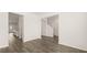 Bright living room with hardwood floors offers views to the kitchen and stairs at 1288 Hollingsworth Way, Dacula, GA 30019