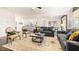Bright and airy living room open to the kitchen with a large rug and comfortable seating at 1288 Hollingsworth Way, Dacula, GA 30019