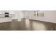 Open living area showcasing hardwood floors, a kitchen, and access to an outdoor space at 1288 Hollingsworth Way, Dacula, GA 30019