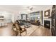 Spacious living room with a fireplace, open to the modern kitchen, with hardwood flooring at 1288 Hollingsworth Way, Dacula, GA 30019