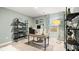 Well-lit home office with a desk, shelving, and bright light provided by the window at 1288 Hollingsworth Way, Dacula, GA 30019