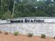 Stone sign at Brooks Station community entrance surrounded by lush greenery at 1288 Hollingsworth Way, Dacula, GA 30019