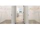 Spacious walk-in closet with ample hanging space and neutral carpeting leading to the bathroom at 1288 Hollingsworth Way, Dacula, GA 30019